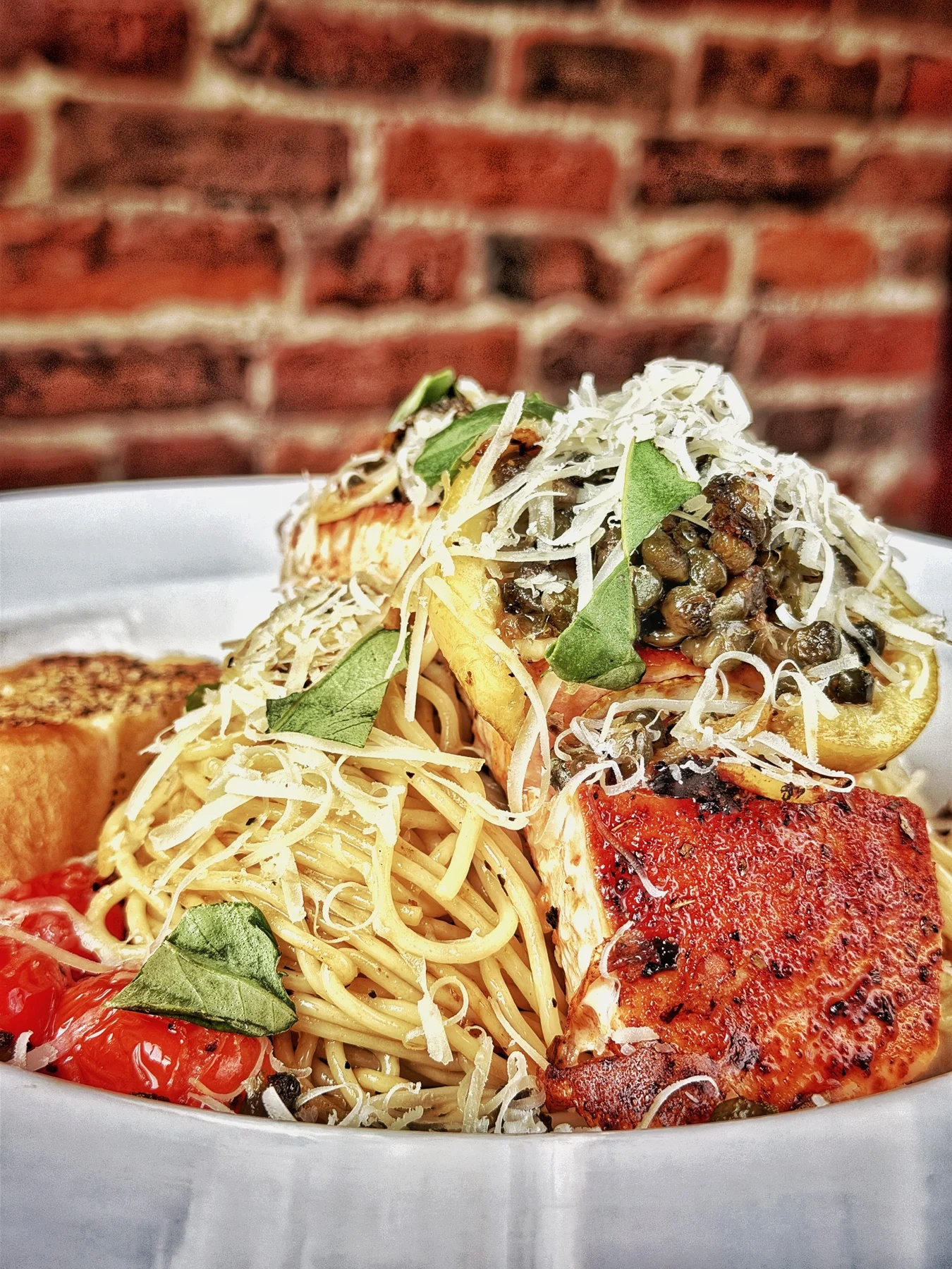Smoke and Spice Salmon over organic semolina spaghetti with capers and lemon.