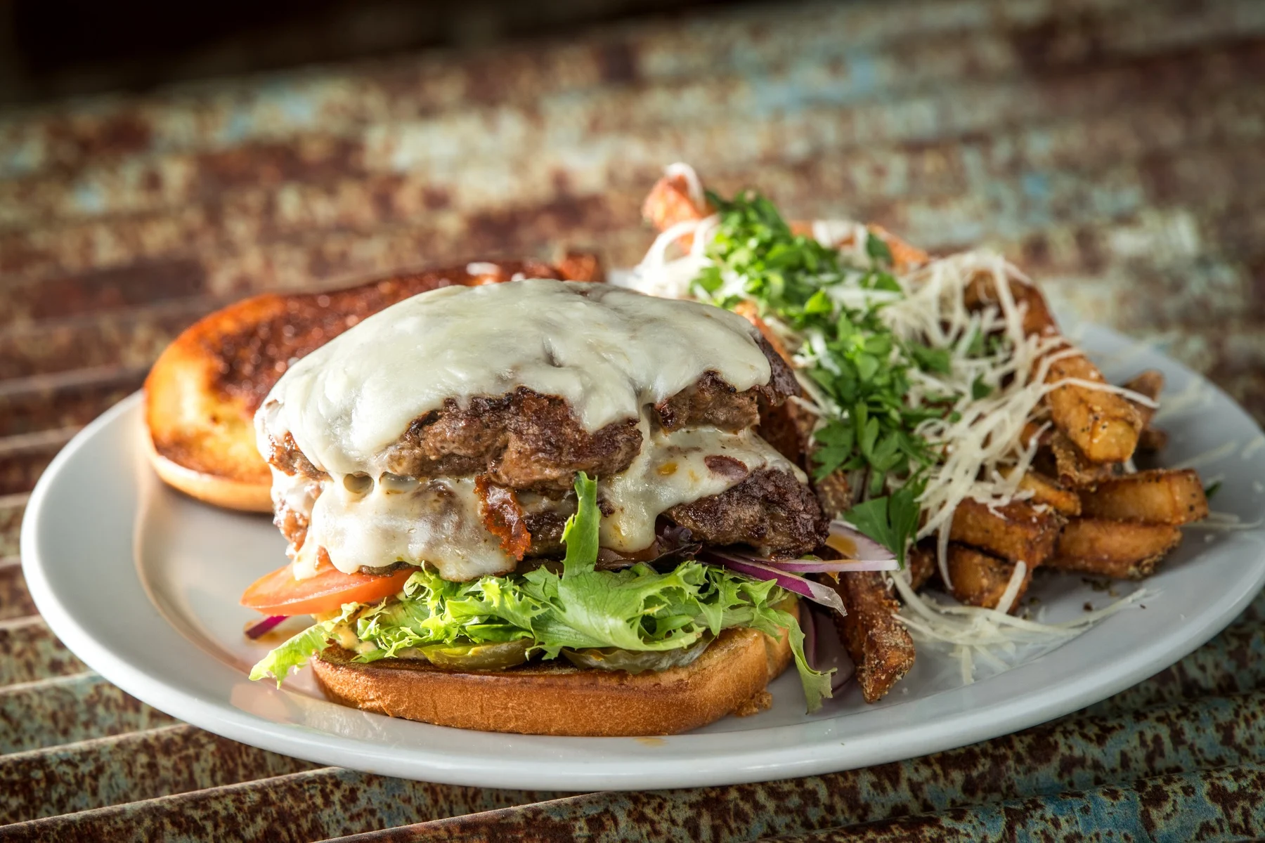 Double burger pictured, served with hand-cut fries.